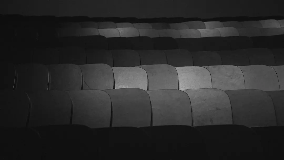 Rows of empty seats in black and white, waiting for the next game you might stream with Nufu TV