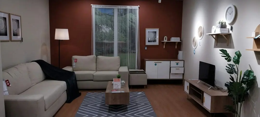 A living room with a sofa, a floor lamp and a TV on a low cabinet, ready to watch sports with Nufu TV instead of cable