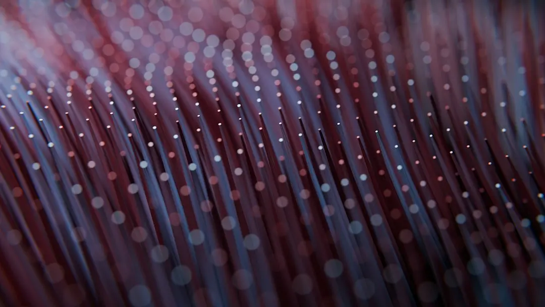 Fiber optic strands glowing red and blue in the dark, the kind of internet connection Nufu TV streams over